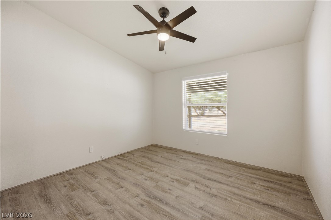 1531 West Harris Farm Road Pahrump, NV 89060 - Photo 31 of 37 A quiet bedroom with a ceiling fan offers wood flooring and ample natural light.