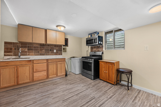 88 East C Street Springville, UT 84663 - Photo 21 of 32 Kitchenette featuring wood-finish flooring, light wood cabinetry, a tiled backsplash, a built-in sink, and a range with an overhead microwave