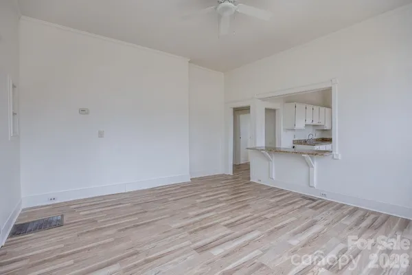 a kitchen with granite countertop white cabinets and a sink