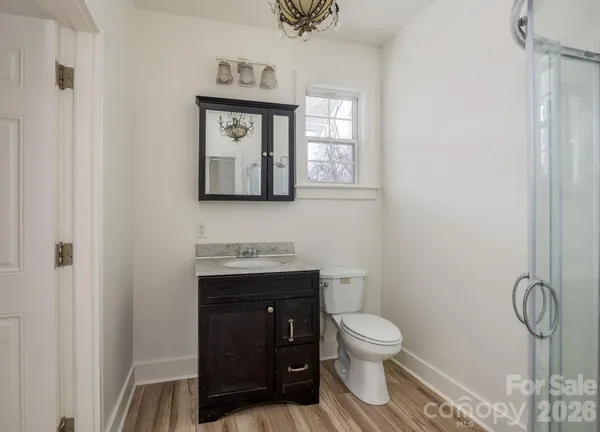 a bathroom with a glass shower door