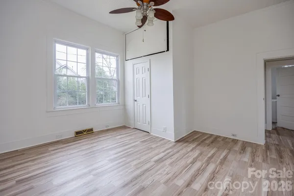 a bedroom with a bed and a potted plant