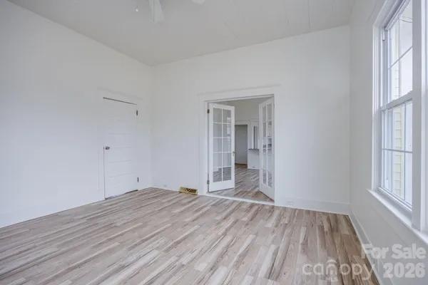 a view of empty room with wooden floor