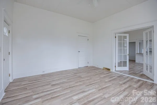 a view of a room with wooden floor and a window