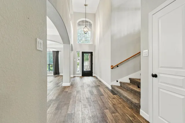 a view of entryway and hall with wooden floor