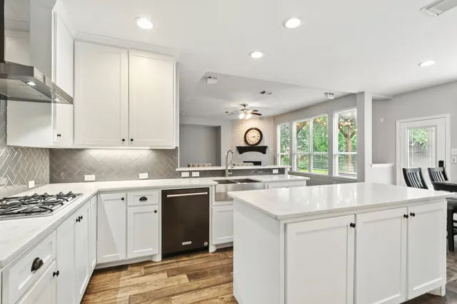 a kitchen with sink stove and cabinets