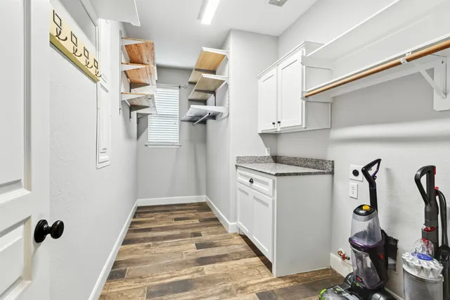 a kitchen with granite countertop a refrigerator and a sink