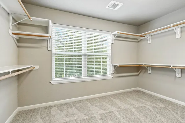 a view of a room with rack on the wall and a window