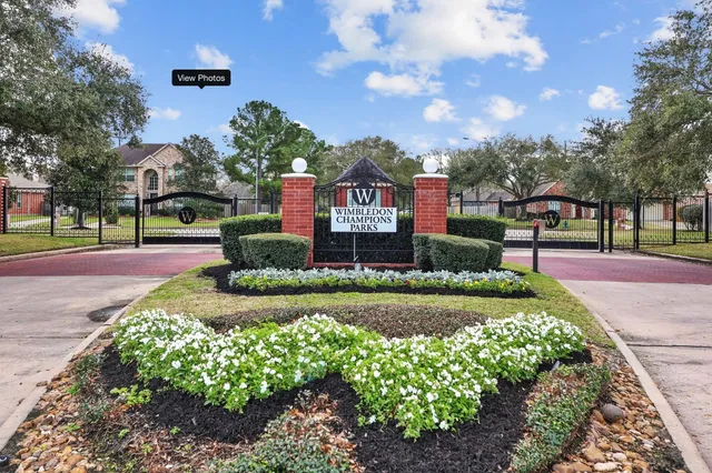 a sign board with a big yard and large trees