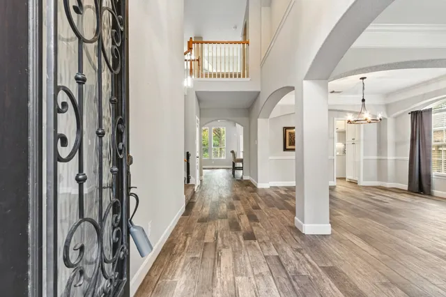 a view of a hallway with wooden floor and entryway