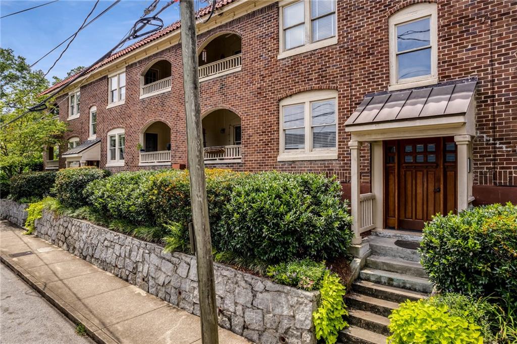 960 Taft Avenue Northeast, Unit 8 Atlanta, GA 30309 - Photo 1 of 1 a front view of a house with plants