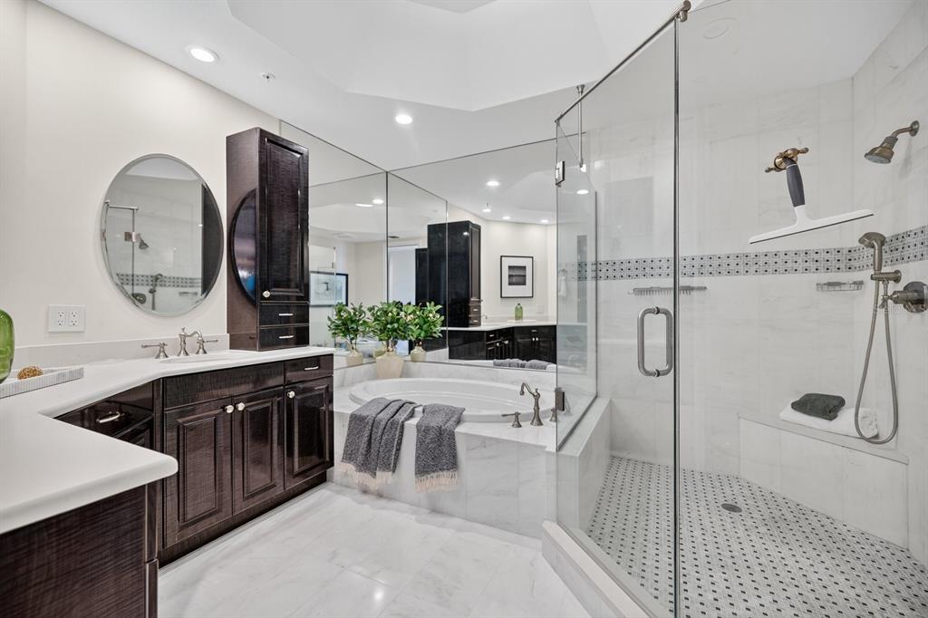 415 L L Ambiance Drive, Unit C403 Longboat Key, FL 34228 - Photo 21 of 81 a large bathroom with a double vanity sink a large mirror and shower
