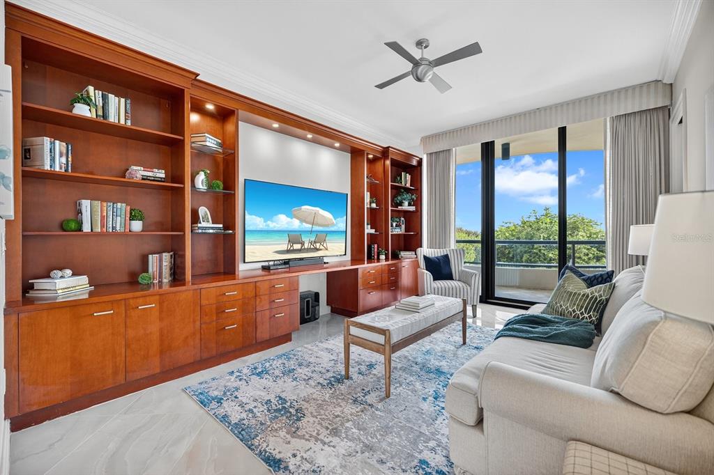 415 L L Ambiance Drive, Unit C403 Longboat Key, FL 34228 - Photo 27 of 81 a living room with furniture a rug and a flat screen tv