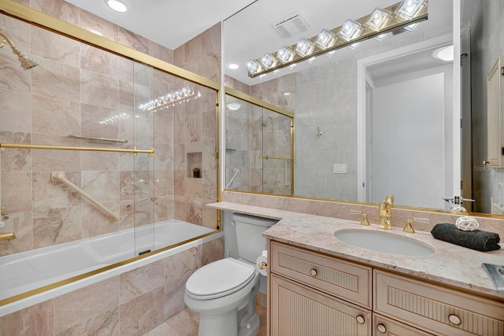 415 L L Ambiance Drive, Unit C403 Longboat Key, FL 34228 - Photo 32 of 81 a bathroom with a granite countertop sink a toilet and bathtub