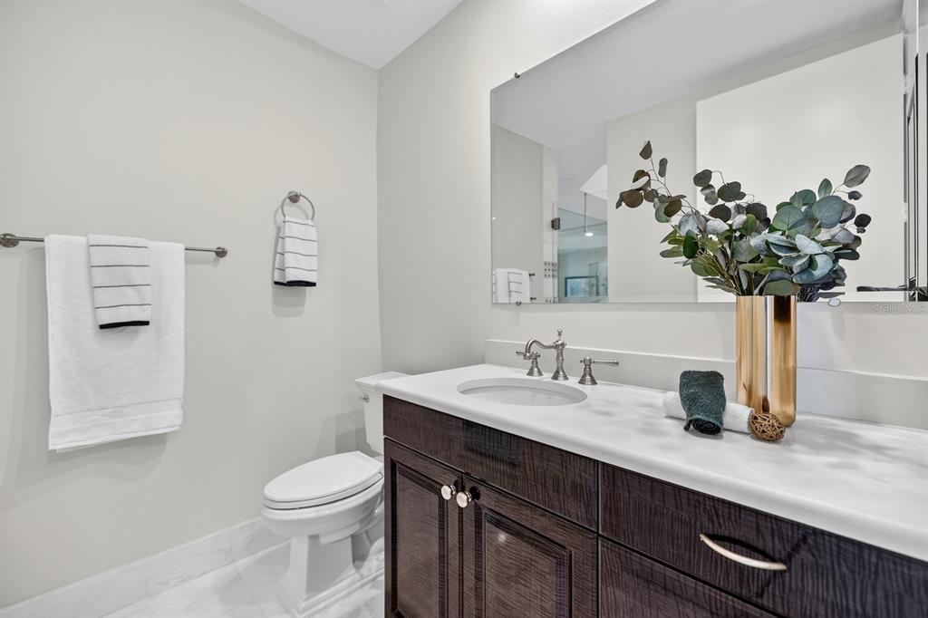 415 L L Ambiance Drive, Unit C403 Longboat Key, FL 34228 - Photo 33 of 81 a bathroom with a sink a toilet and a mirror