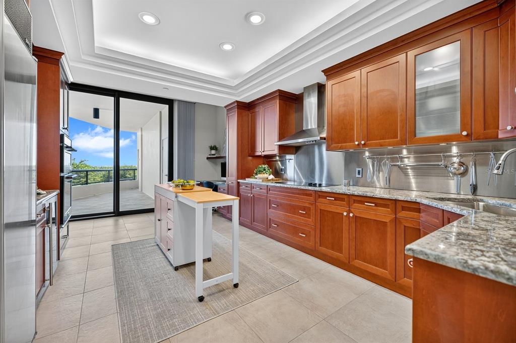 415 L L Ambiance Drive, Unit C403 Longboat Key, FL 34228 - Photo 35 of 81 a kitchen with stainless steel appliances granite countertop sink stove top oven and cabinets