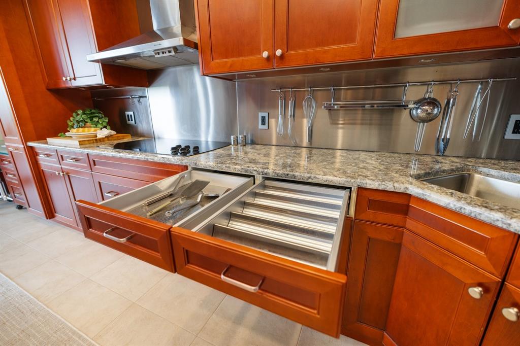 415 L L Ambiance Drive, Unit C403 Longboat Key, FL 34228 - Photo 39 of 81 a view of a kitchen with a sink and cabinets