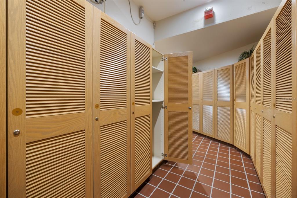 415 L L Ambiance Drive, Unit C403 Longboat Key, FL 34228 - Photo 52 of 81 a view of a hallway with wooden floor and a bathroom