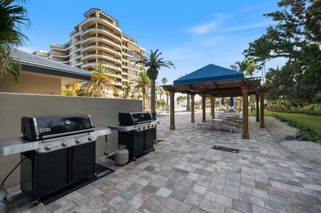 415 L L Ambiance Drive, Unit C403 Longboat Key, FL 34228 - Photo 66 of 81 a backyard of a house with table and chairs