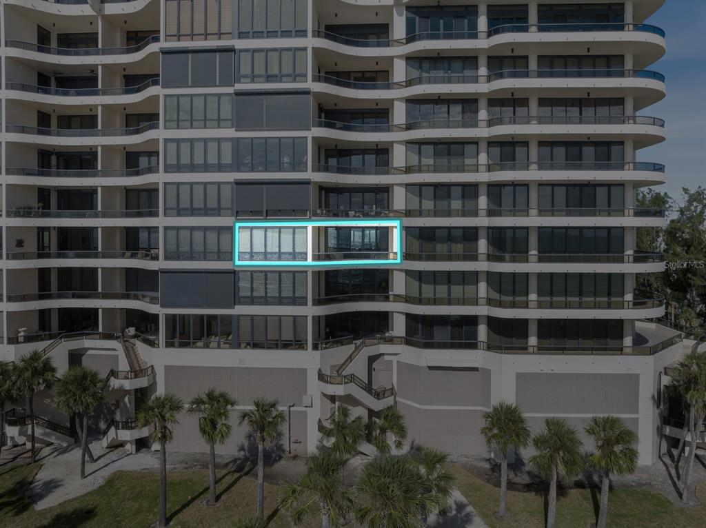 415 L L Ambiance Drive, Unit C403 Longboat Key, FL 34228 - Photo 81 of 81 a view of a house with a large window and a potted plant on a table