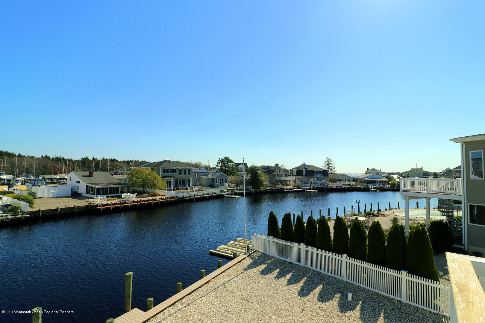 130 Cedar Run Road Bayville, NJ 08721 - Photo 53 of 57 a view of a lake with boats and trees in the background