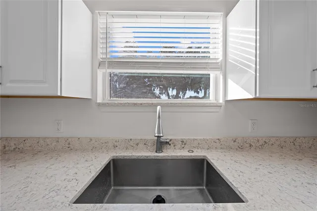 a kitchen with a sink and cabinets