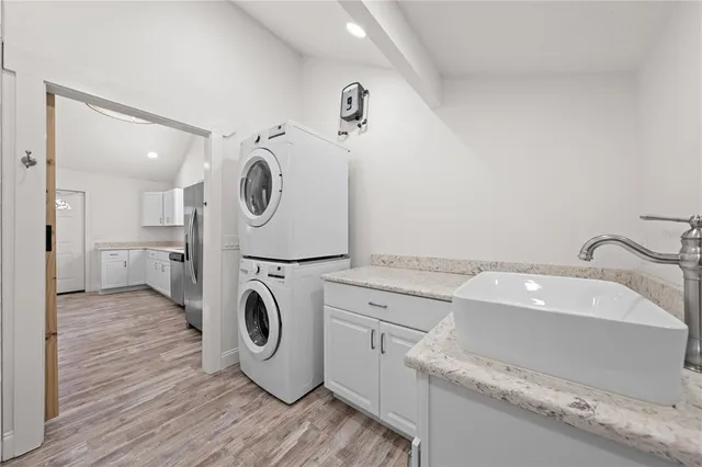 a utility room with sink dryer and washer