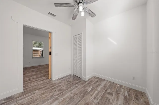 wooden floor in an empty room with a window
