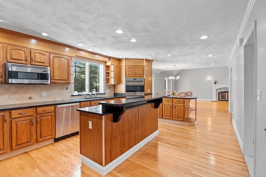 83 Weldon Farm Road Rowley, MA 01969 - Photo 12 of 41 a kitchen with stainless steel appliances granite countertop a stove and a sink