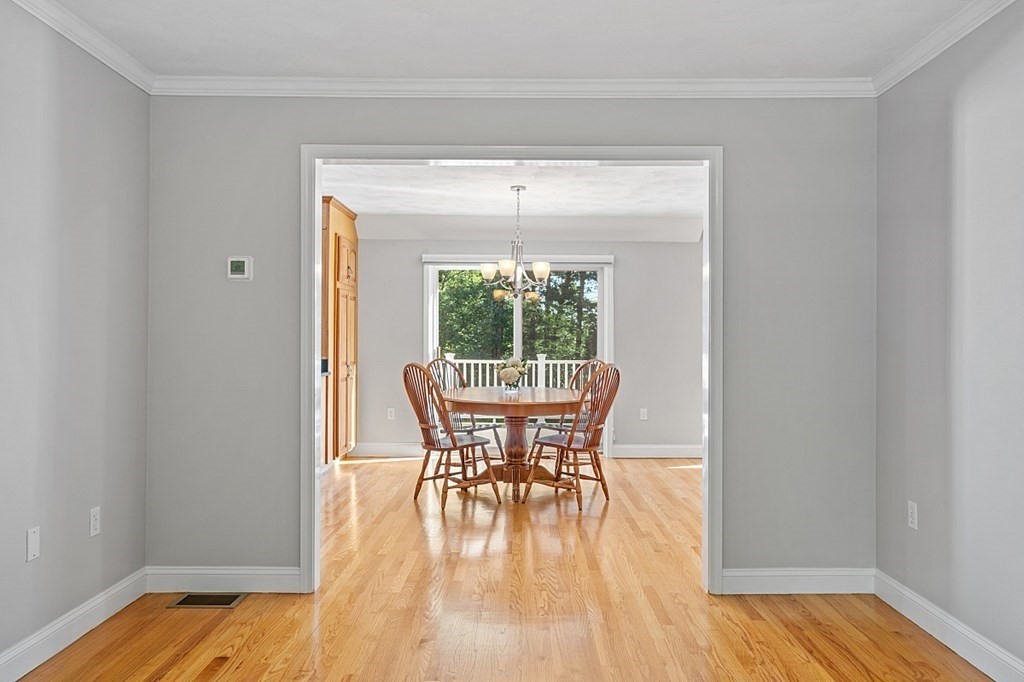 83 Weldon Farm Road Rowley, MA 01969 - Photo 13 of 41 a dining room with furniture wooden floor and a chandelier