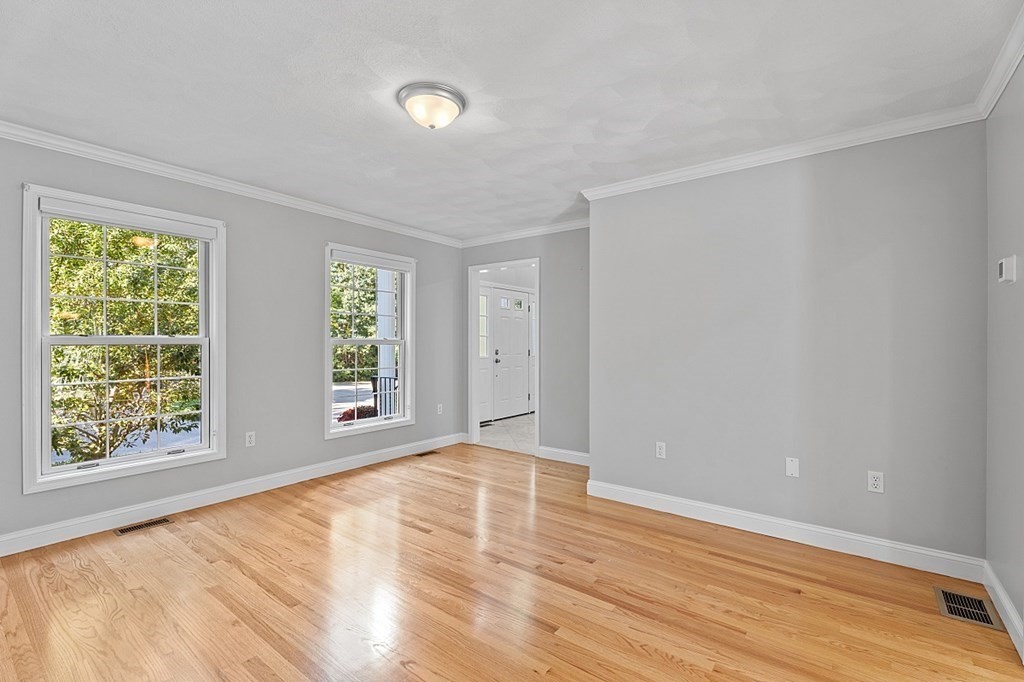 83 Weldon Farm Road Rowley, MA 01969 - Photo 14 of 41 a view of an empty room with wooden floor and a window
