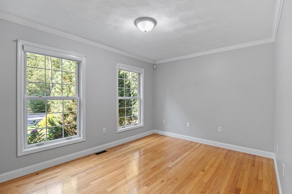 83 Weldon Farm Road Rowley, MA 01969 - Photo 16 of 41 an empty room with wooden floor and windows