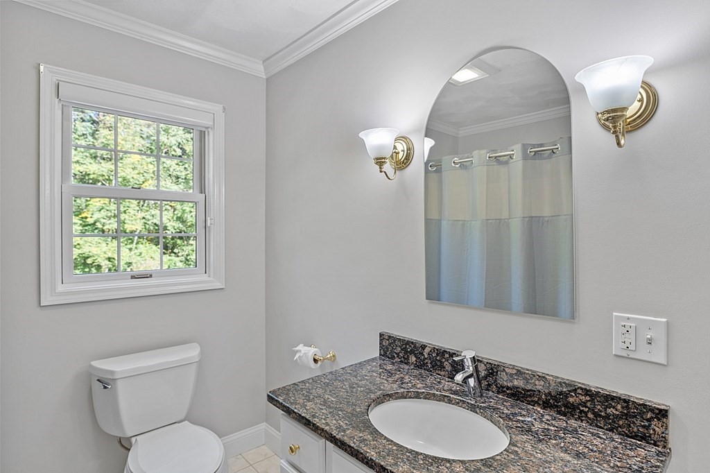 83 Weldon Farm Road Rowley, MA 01969 - Photo 17 of 41 a bathroom with a granite countertop toilet a sink and a mirror