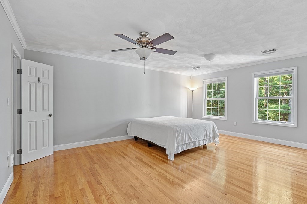 83 Weldon Farm Road Rowley, MA 01969 - Photo 26 of 41 a bedroom with a bed and wooden floor