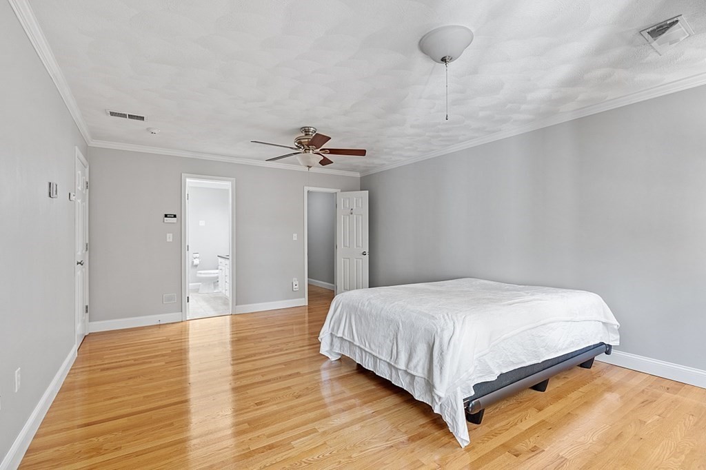 83 Weldon Farm Road Rowley, MA 01969 - Photo 27 of 41 a bedroom with a bed and a chandelier