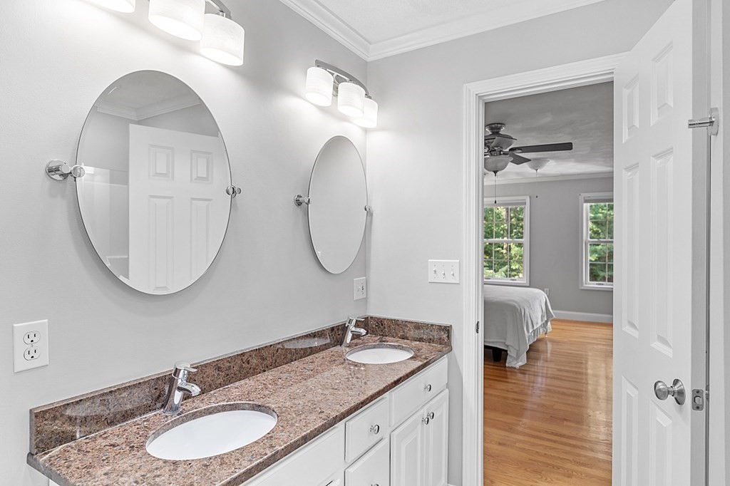 83 Weldon Farm Road Rowley, MA 01969 - Photo 28 of 41 a bathroom with a granite countertop double vanity sinks and a mirror