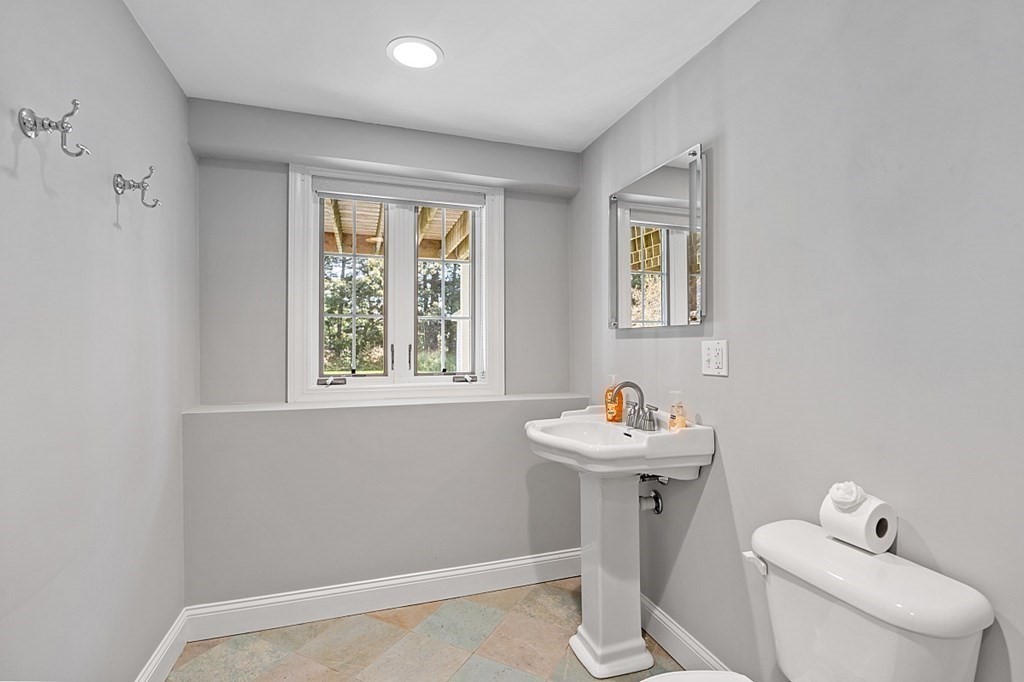 83 Weldon Farm Road Rowley, MA 01969 - Photo 32 of 41 a bathroom with a sink mirror and toilet