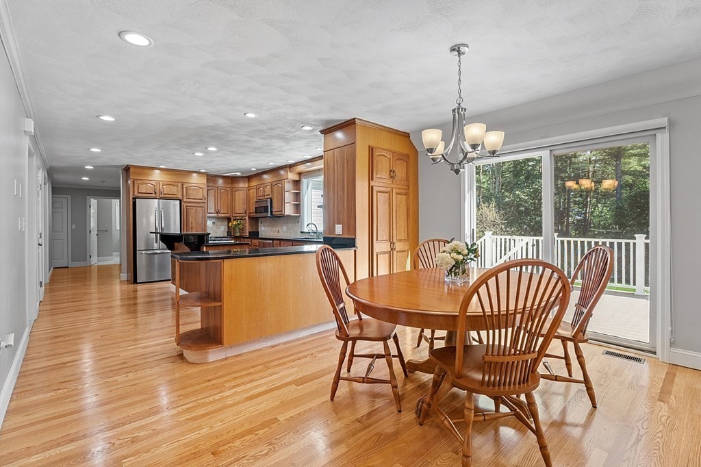 83 Weldon Farm Road Rowley, MA 01969 - Photo 6 of 41 a dining room with furniture a chandelier and wooden floor