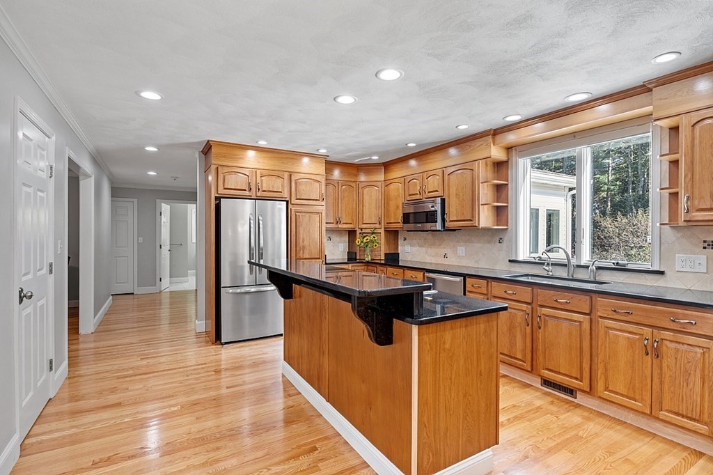 83 Weldon Farm Road Rowley, MA 01969 - Photo 7 of 41 a kitchen with stainless steel appliances granite countertop a stove and a sink