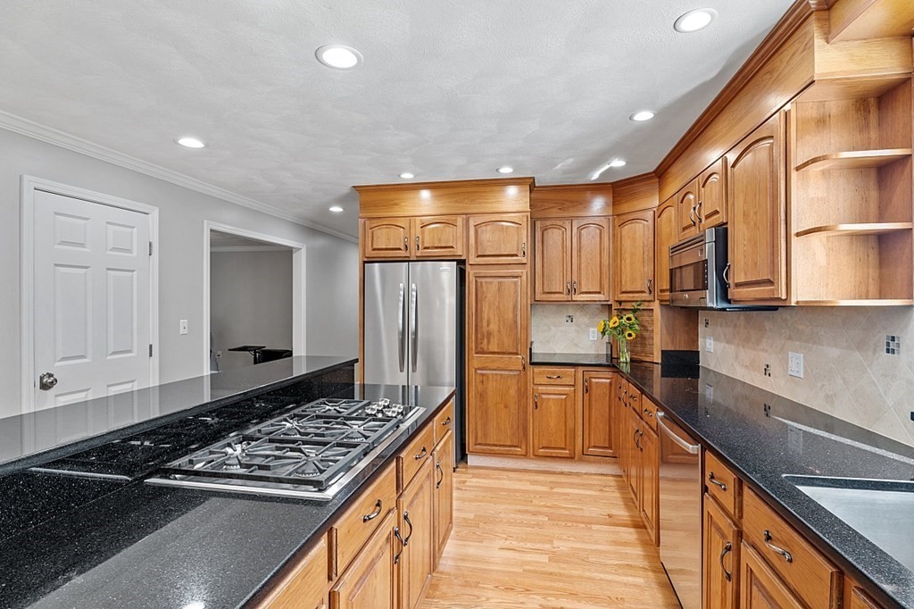 83 Weldon Farm Road Rowley, MA 01969 - Photo 10 of 41 a kitchen with stainless steel appliances granite countertop a sink stove and refrigerator
