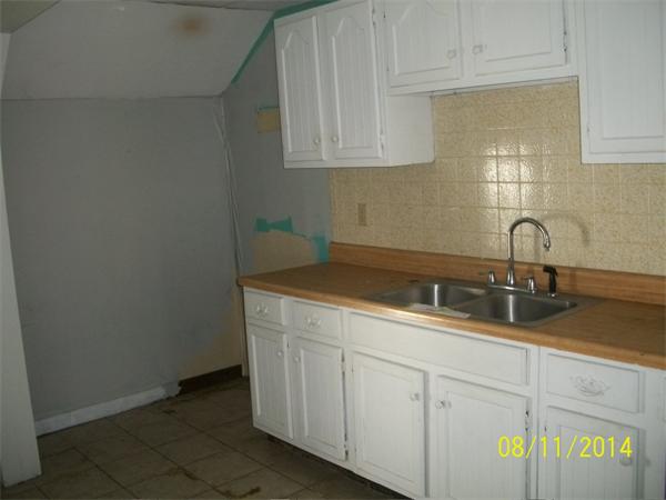 527 Division Street Fall River, MA 02721 - Photo 27 of 30 a kitchen with a sink and cabinets