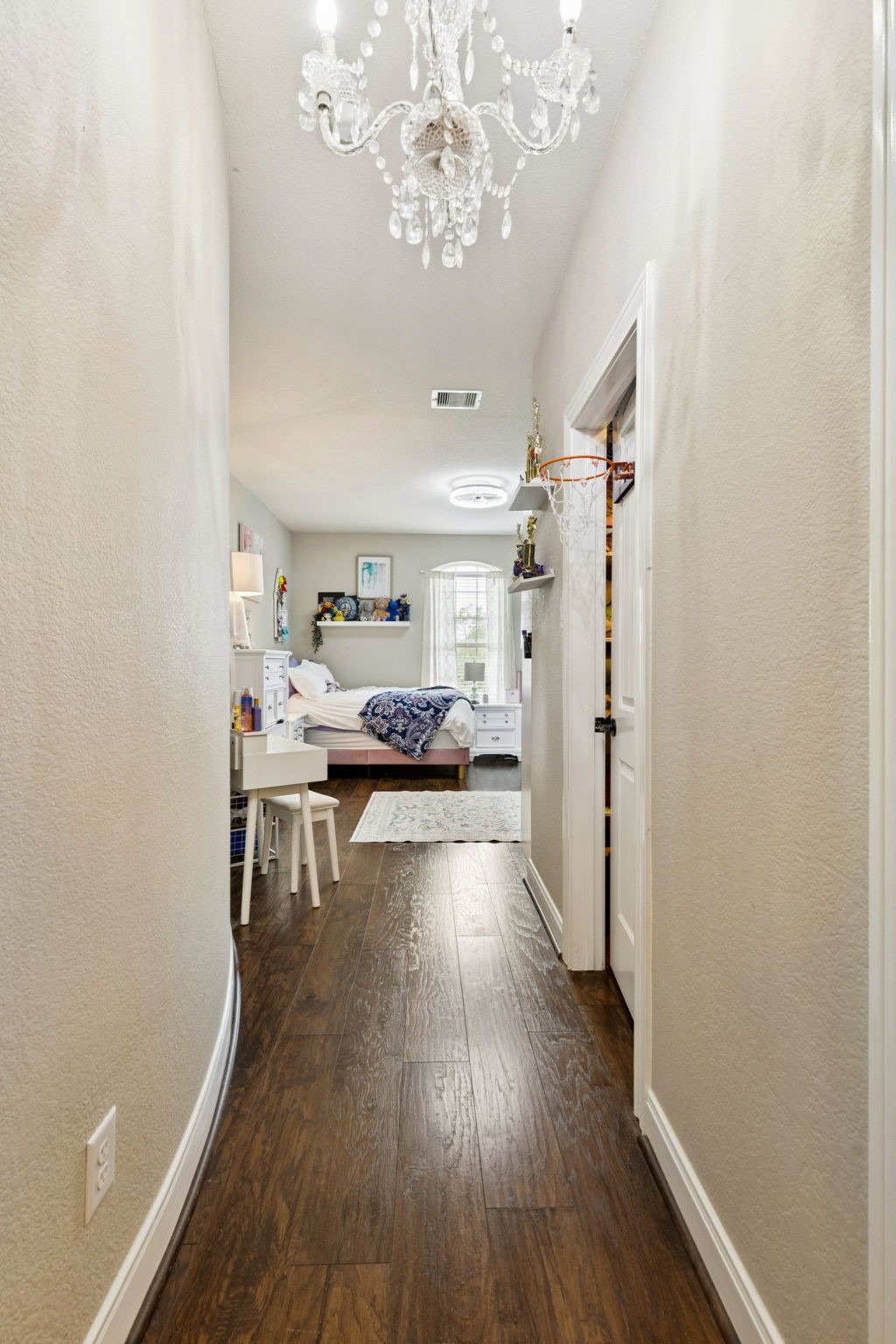 1118 Fragile Sail Court Katy, TX 77494 - Photo 20 of 35 This elegant upstairs hallway is highlighted by a stunning crystal chandelier and wide-plank laminate floors. This private hallway leads to a spacious secondary bedroom suite complete with its own full bathroom and walk-in closet—ideal for guests, teens, or multigenerational living with added privacy and comfort.