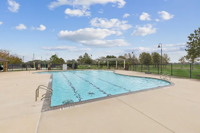 a view of a swimming pool with a lake view and in back