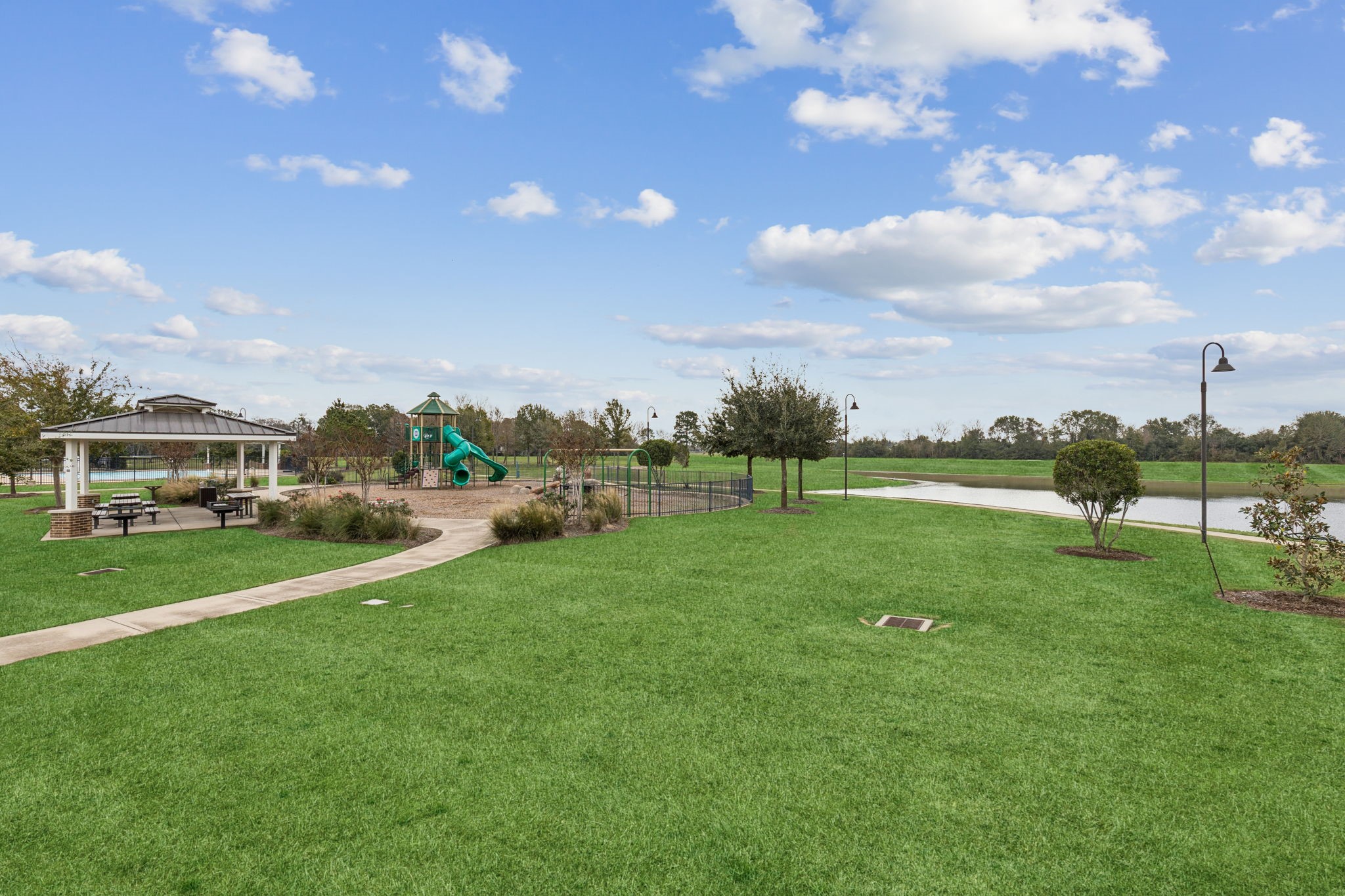 1118 Fragile Sail Court Katy, TX 77494 - Photo 31 of 35 Trails of Katy offers a thoughtfully designed community playground with climbing structures, swings, and open green surroundings—an ideal spot for outdoor play and everyday enjoyment. This amenity adds to the neighborhood’s focus on walkable spaces and an active, outdoor lifestyle.