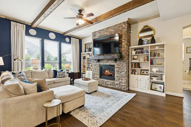 a living room with furniture fireplace and flat screen tv