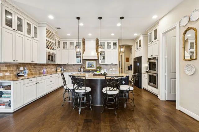 a large kitchen with a table and chairs