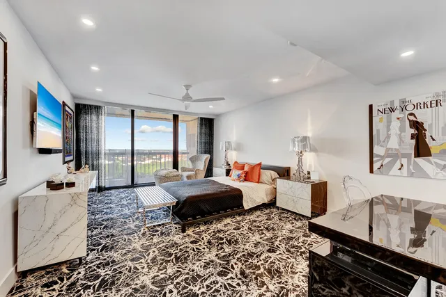 a bed room with furniture and a flat screen tv