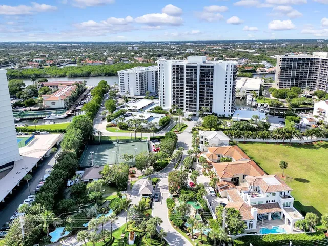 an aerial view of lake and residential houses with outdoor space