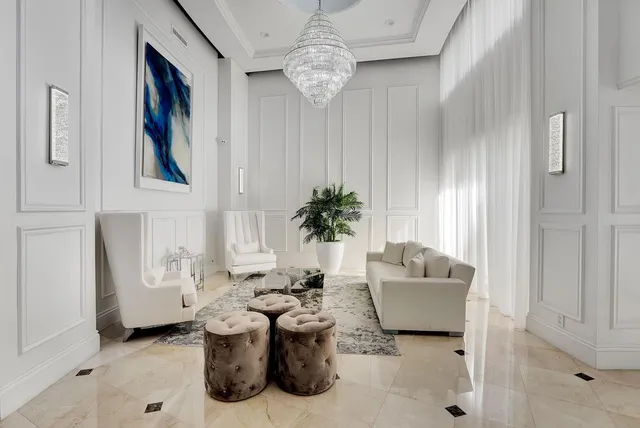 a living room with furniture and a chandelier