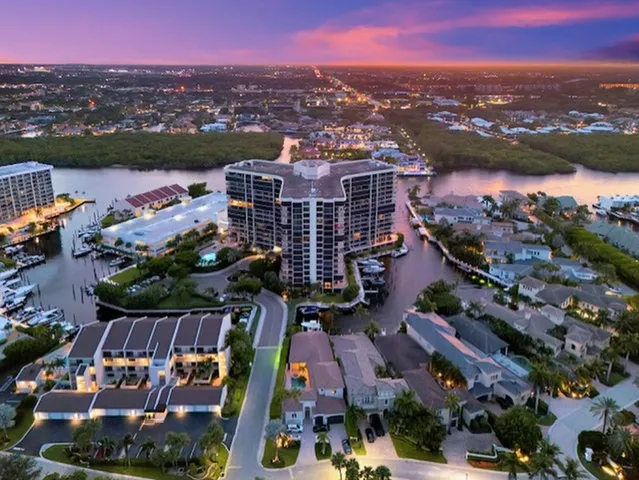 an aerial view of lake and residential houses with outdoor space