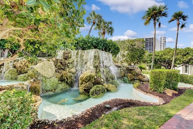 a view of a balcony with wooden floor and a floor to ceiling window